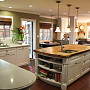 Los Altos Remodel - AFTER: New kitchen
View from the same location. With the laundry room and garage walls removed, this becomes open, light-filled space. A dramatic rustic wood countertop island anchors the room.

